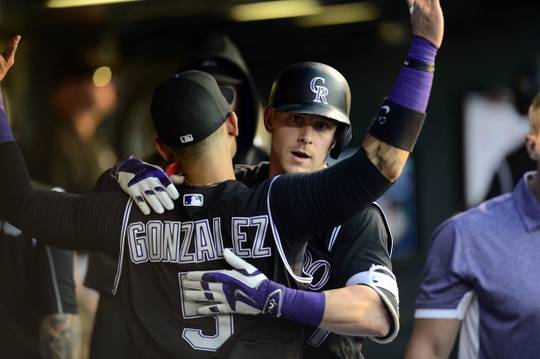 Jul 7, 2016; Denver, CO, USA; Colorado Rockies shortstop Trevor Story (27) celebrates his solo home run with right fielder Carlos Gonzalez (5) celebrate in the fifth inning against the Philadelphia Phillies at Coors Field. Mandatory Credit: Ron Chenoy-USA TODAY Sports